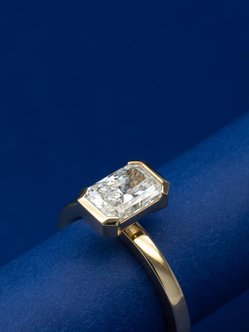 Bespoke radiant cut half bezel solitaire engagement ring in 18K yellow gold with 1.24ct natural diamond — handcrafted by Benjamin Rose Melbourne