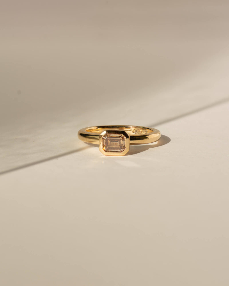 Bespoke Bella emerald cut bezel solitaire engagement ring in 18K yellow gold with champagne diamond — handcrafted by Benjamin Rose Melbourne