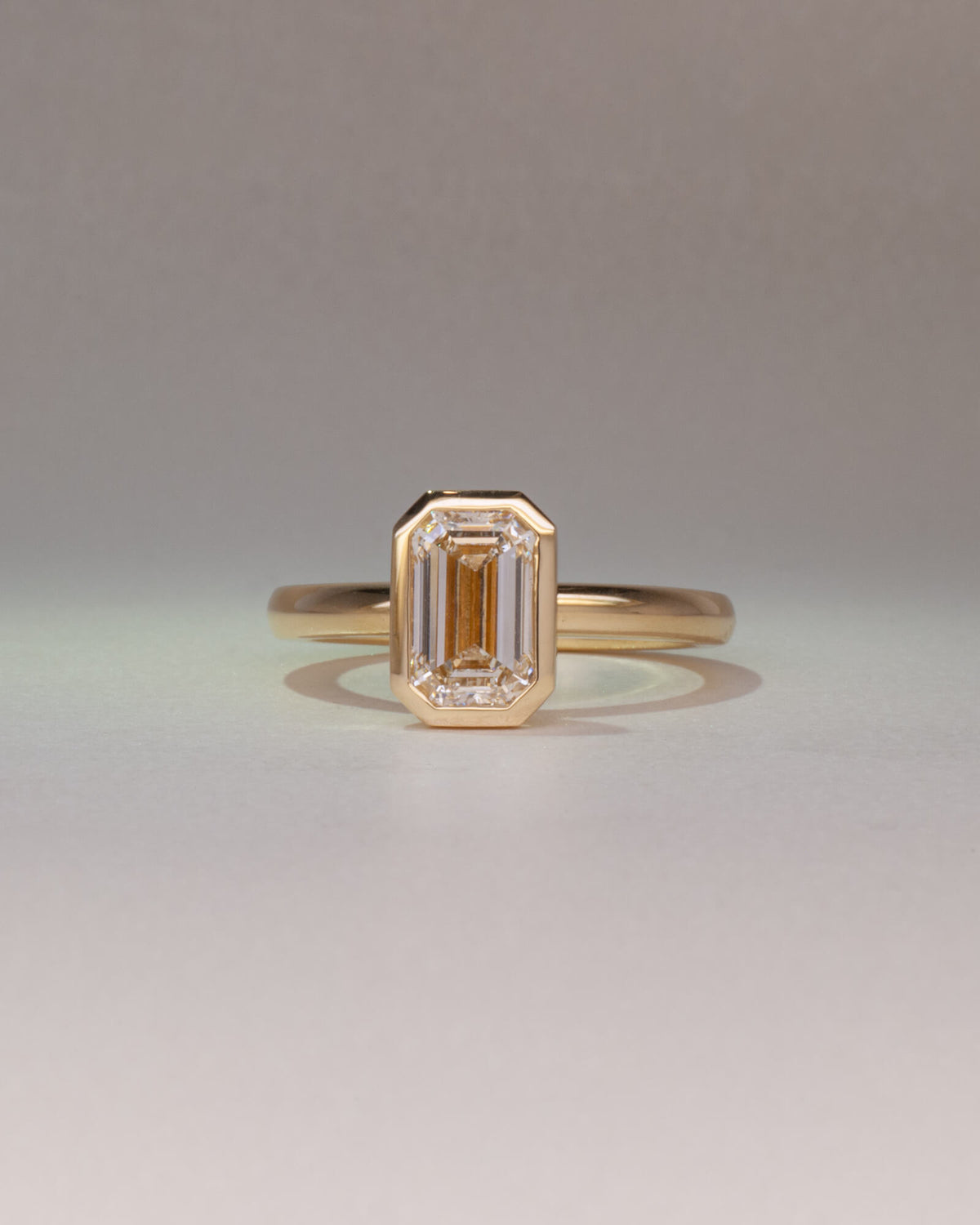 Bespoke Bella emerald cut bezel solitaire engagement ring in 18K yellow gold with 1.50ct natural diamond — handcrafted by Benjamin Rose Melbourne