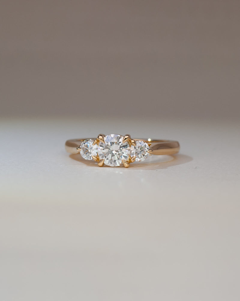 Bespoke Bianca trilogy engagement ring in 18K yellow gold with 0.56ct round brilliant lab diamond and lab diamond side stones — handcrafted by Benjamin Rose Melbourne