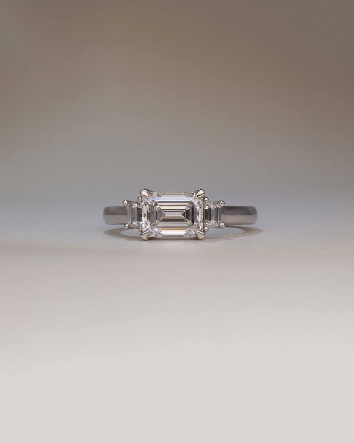 Bespoke diamond trilogy engagement ring in platinum with 2.06ct emerald cut lab diamond and trapezoid step cut lab diamond side stones — handcrafted by Benjamin Rose Melbourne