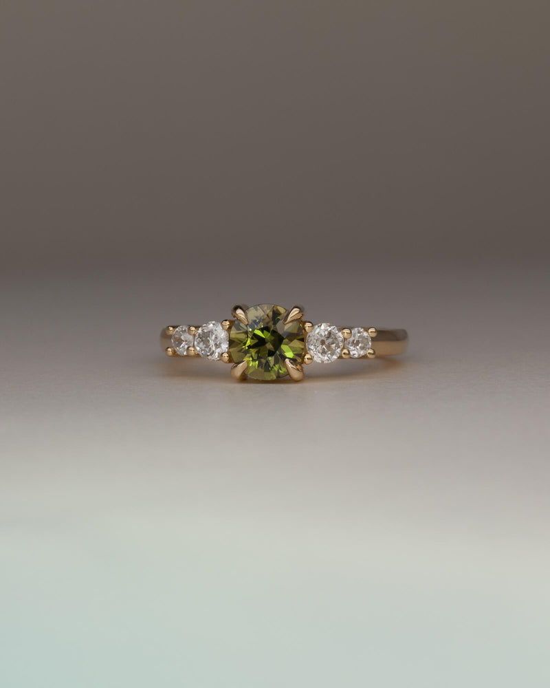 Bespoke five stone engagement ring in 18K yellow gold with 0.86ct round Australian sapphire and natural heirloom diamond side stones — handcrafted by Benjamin Rose Melbourne