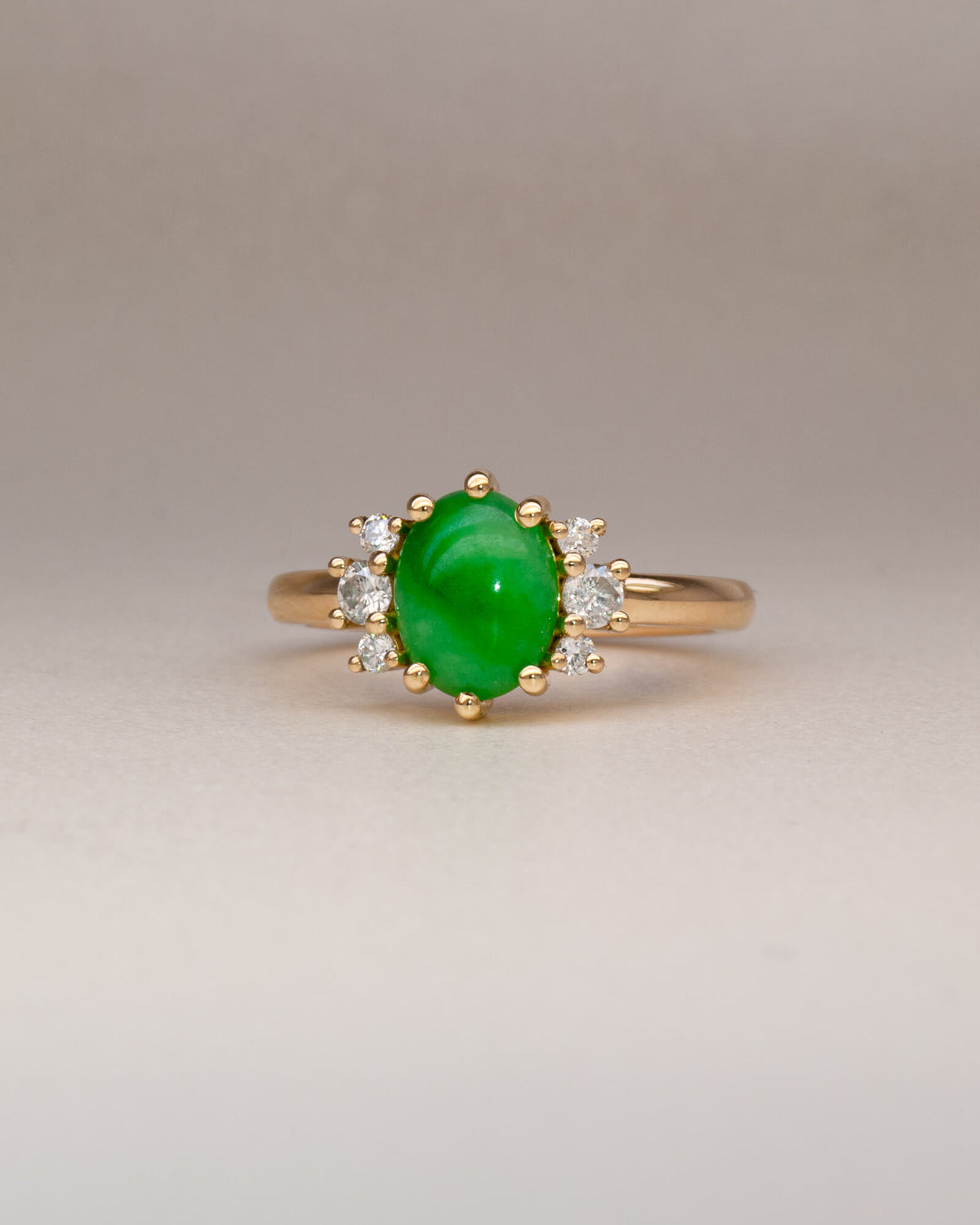 Bespoke jade cluster engagement ring in 18K yellow gold with oval jade cabochon and natural heirloom diamond surround — handcrafted by Benjamin Rose Melbourne