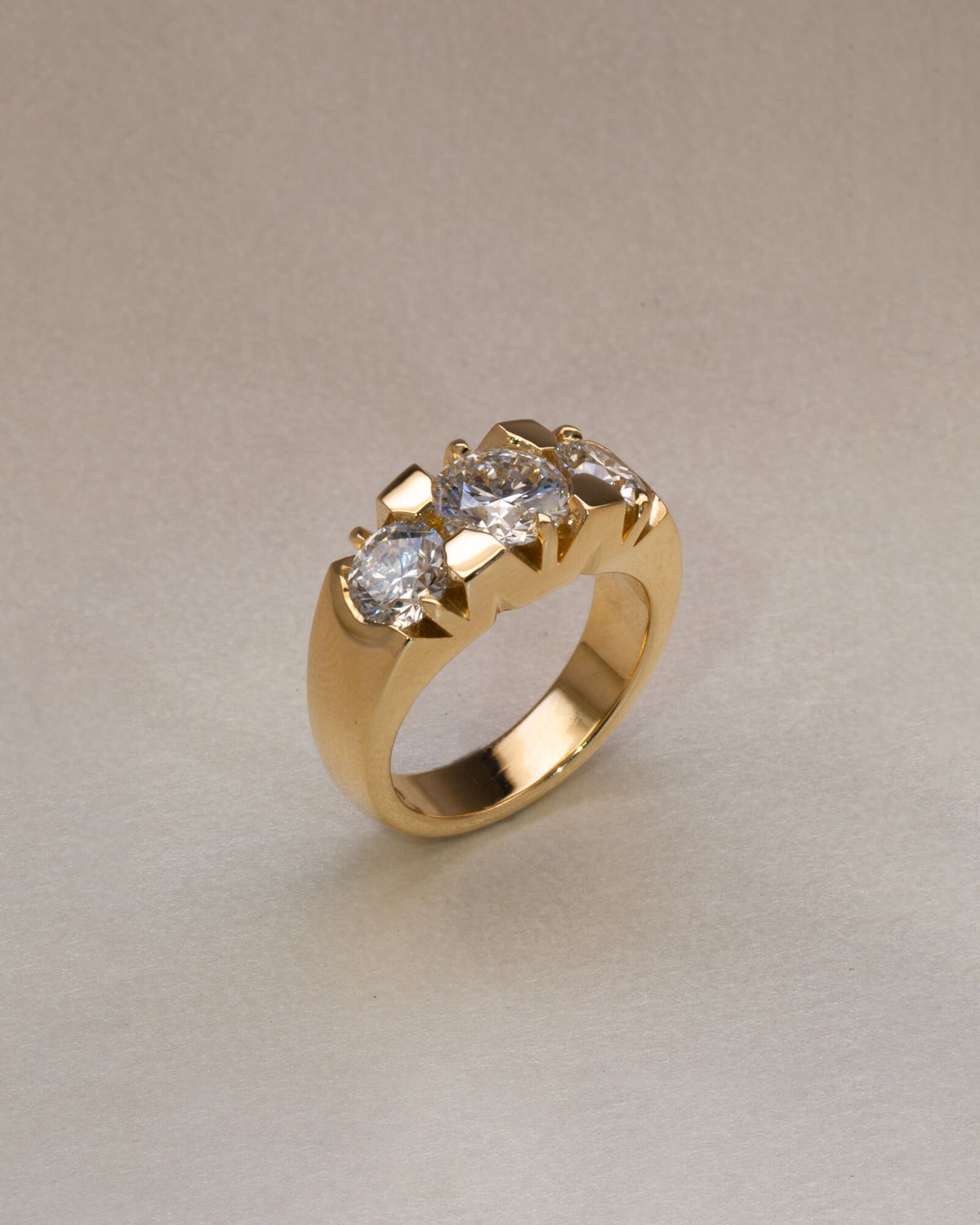 Bespoke Nika three stone engagement ring in 18K yellow gold with 1.21ct round brilliant lab diamond and 0.71ct lab diamond side stones — handcrafted by Benjamin Rose Melbourne