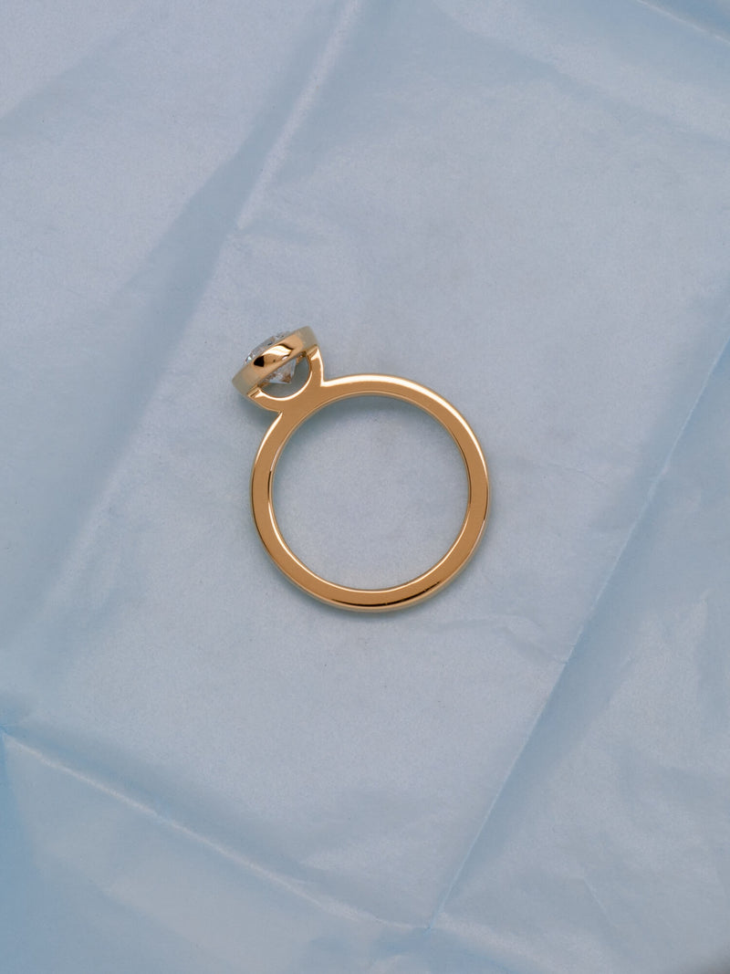 Bespoke round bezel solitaire engagement ring in 18K yellow gold with 1.01ct natural diamond — handcrafted by Benjamin Rose Melbourne