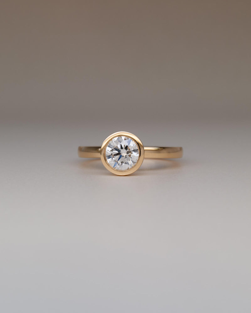 Bespoke round bezel solitaire engagement ring in 18K yellow gold with 1.01ct natural diamond — handcrafted by Benjamin Rose Melbourne