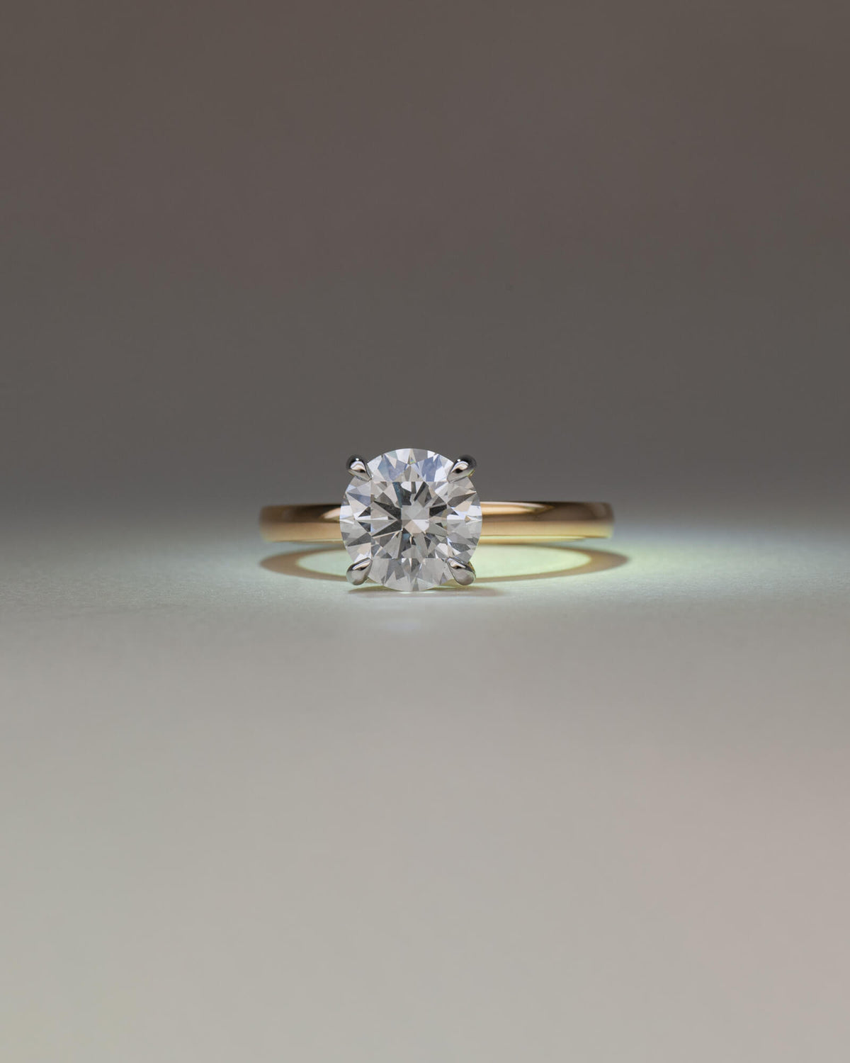 Bespoke round brilliant solitaire engagement ring with talon claw setting in platinum on 18K yellow gold band — 2.01ct lab grown diamond, handcrafted by Benjamin Rose Melbourne