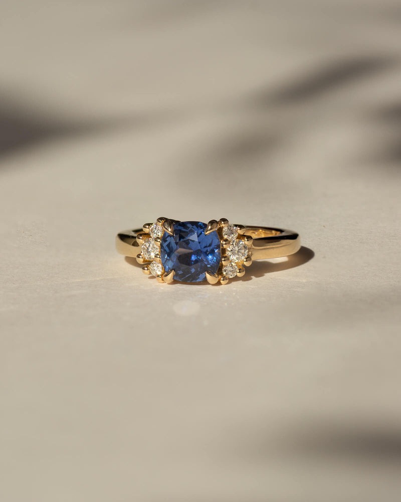 Bespoke sapphire cluster engagement ring in 18K yellow gold with 1.48ct cushion cut Ceylon sapphire and natural diamond surround — handcrafted by Benjamin Rose Melbourne